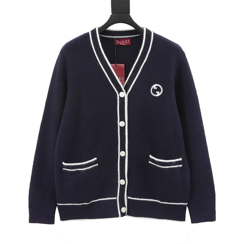 Navy blue Gucci cardigan with white contrast trim, button front, emblem, and pockets